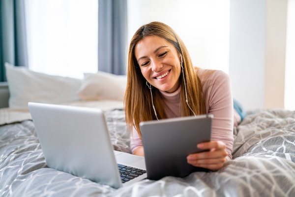 happy-young-woman-using-laptop-at-home-2021-09-01-07-35-28-utc-2